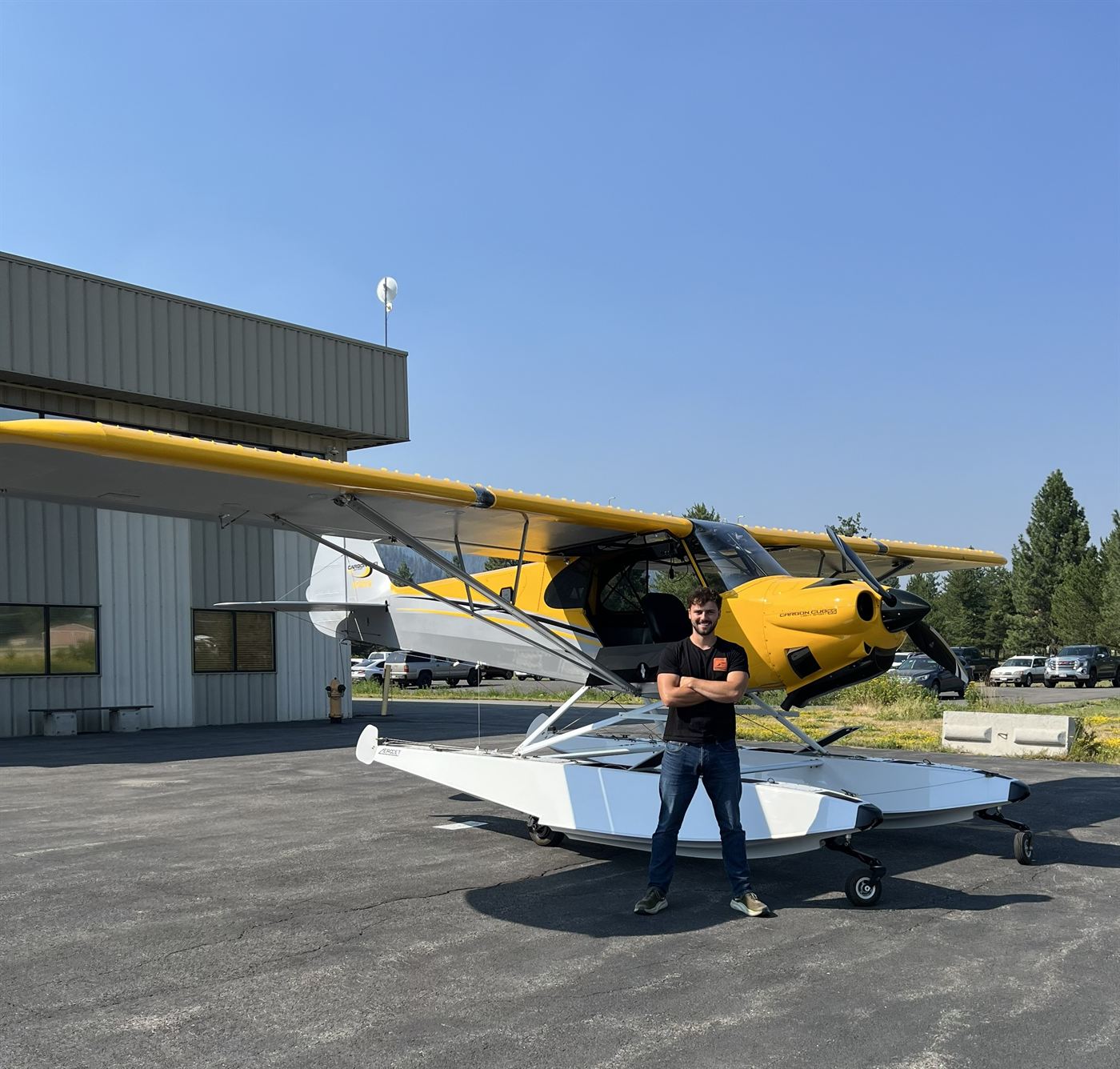 David standing in front of a yellow float-equipped Carbon Cub aircraft